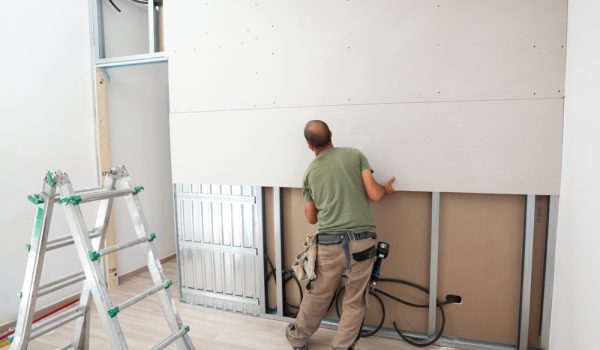 Worker,Building,Plasterboard,Wall.,Working,With,Cutting,Tools,,Fixing,And
